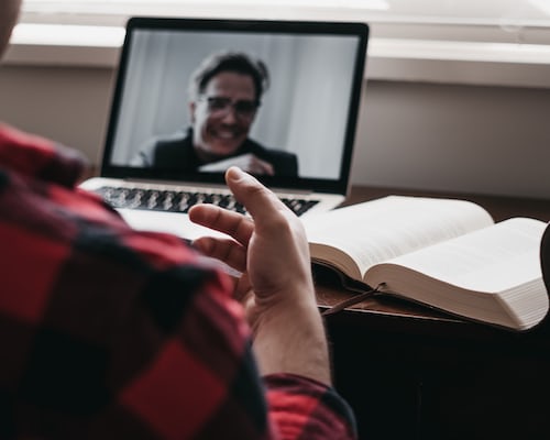 A person screen sharing on a laptop with a new prospective customer