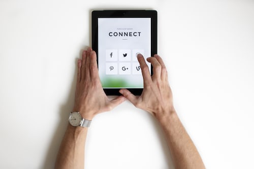 A person using a tablet to set up a virtual sales meeting