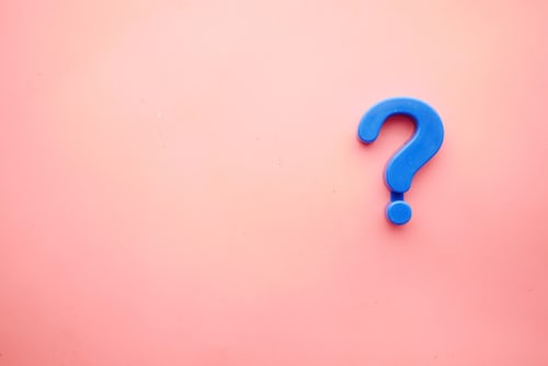 A blue question mark symbol against an orange background